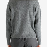 Grey knitwear worn by a person, showing the knitwear fit