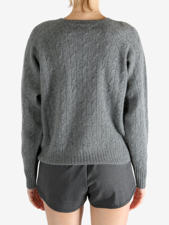 Grey knitwear worn by a person, showing the knitwear fit