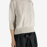 tan knitwear worn by a person, showing the knitwear fit