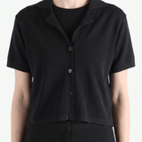 Black shirt worn by a person, showing the shirt's fit