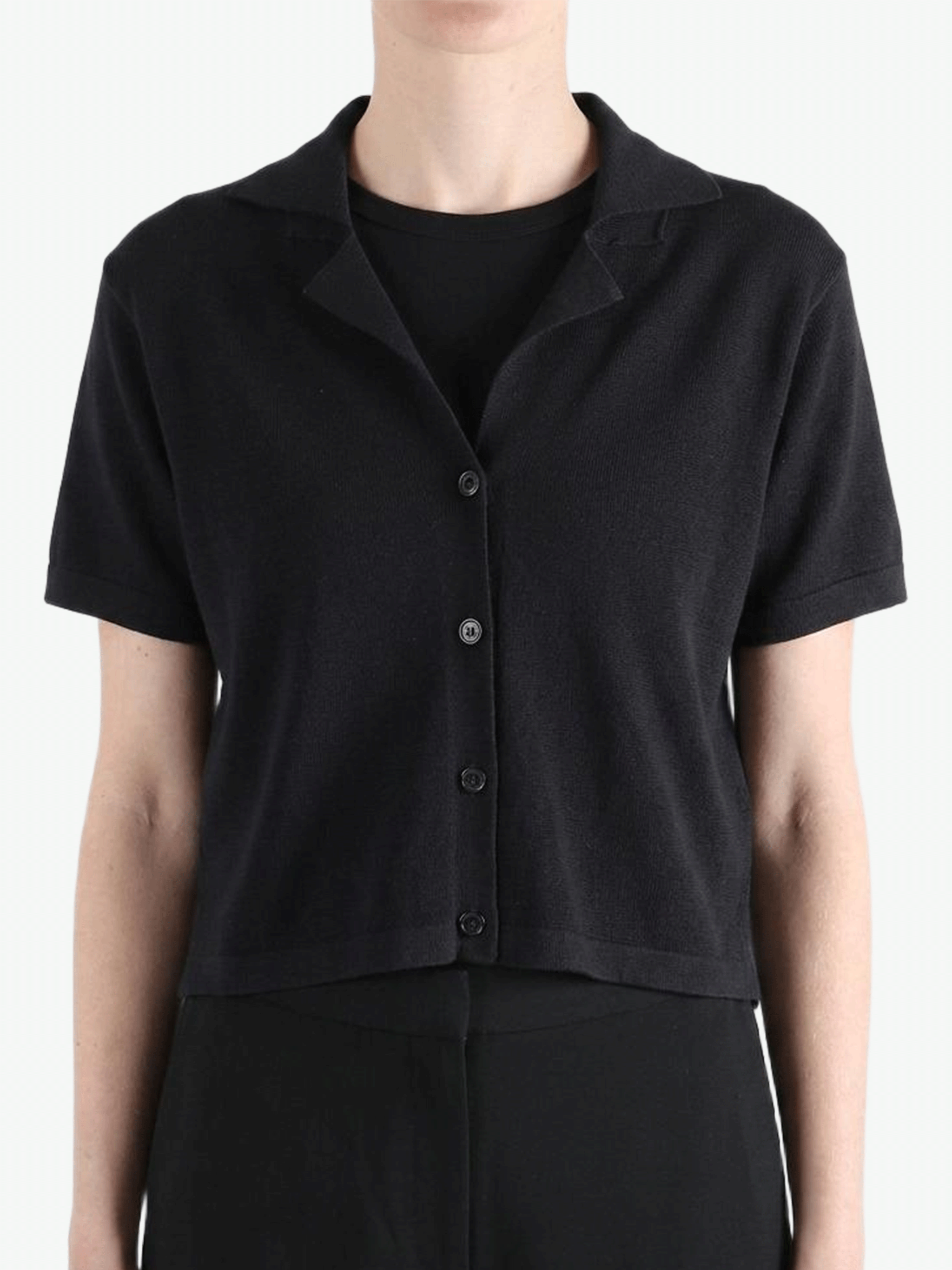 Black shirt worn by a person, showing the shirt's fit