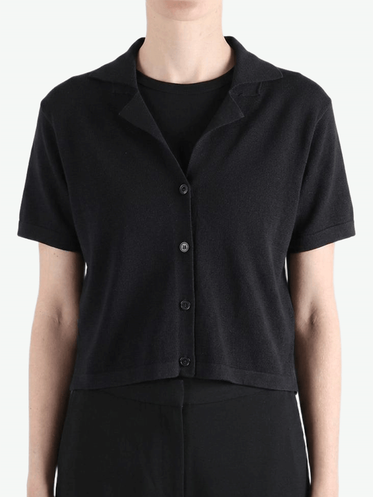 Black shirt worn by a person, showing the shirt's fit