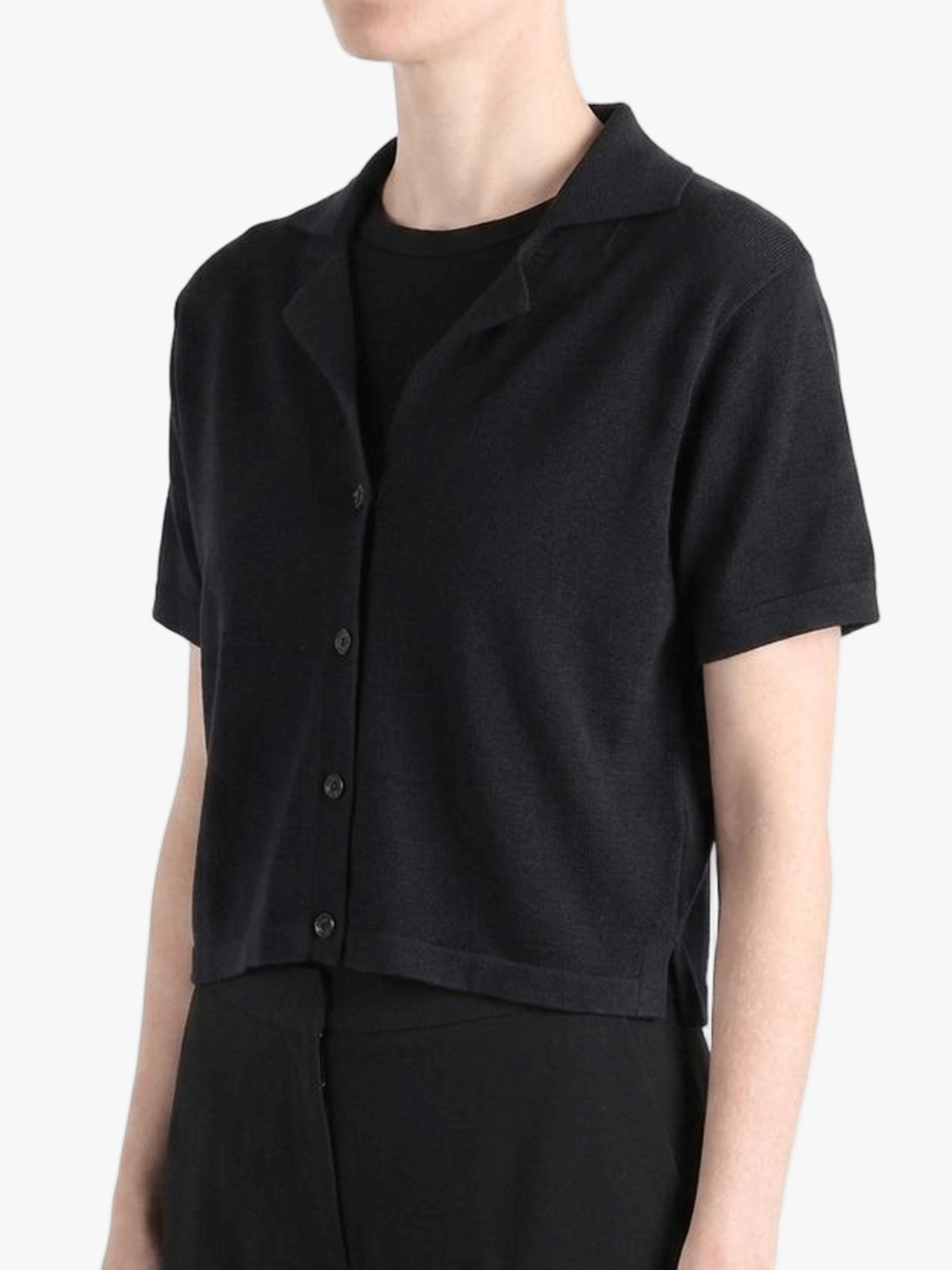 Black shirt worn by a person, showing the shirt's fit