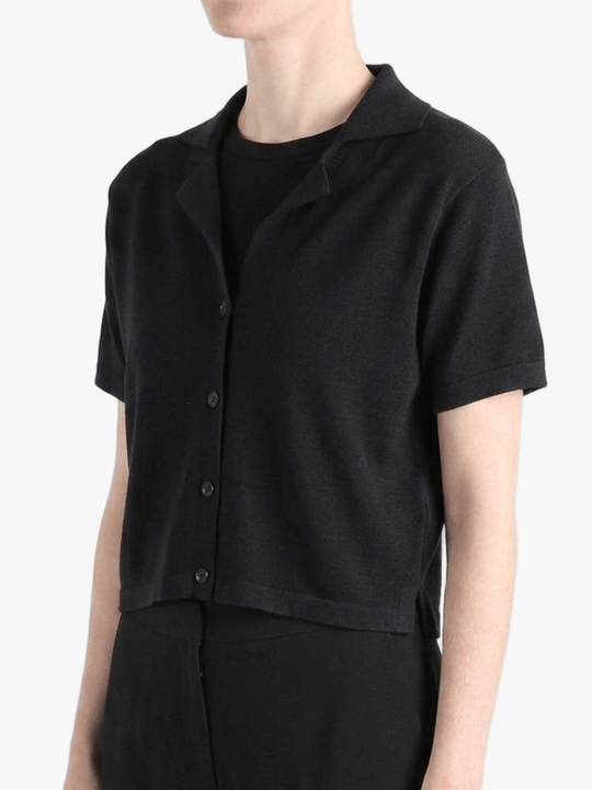 Black shirt worn by a person, showing the shirt's fit