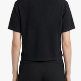 Black shirt worn by a person, showing the shirt's fit
