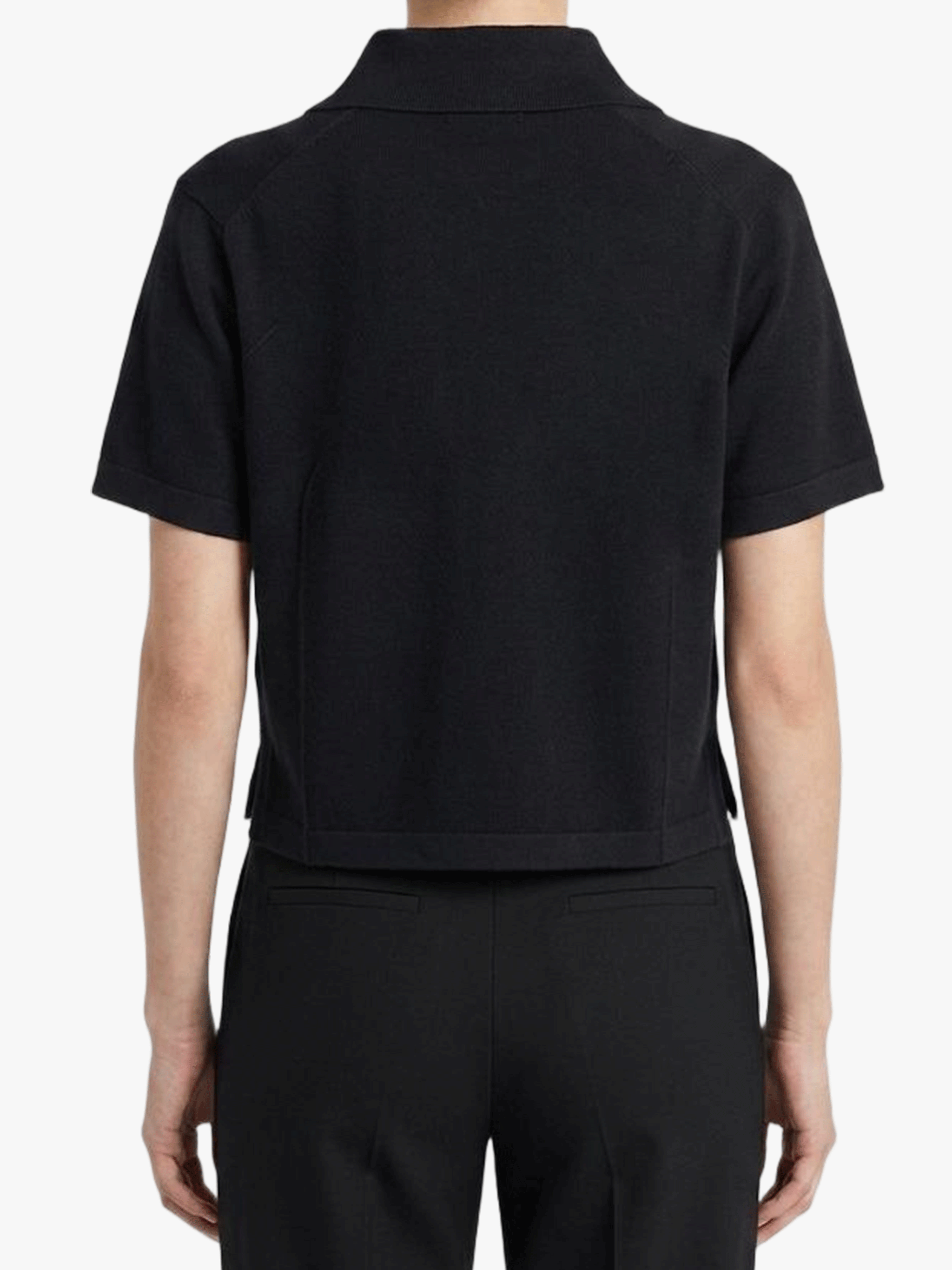 Black shirt worn by a person, showing the shirt's fit