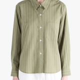 Green shirts worn by a person, showing the shirts's fit