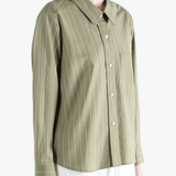 Green shirts worn by a person, showing the shirts's fit
