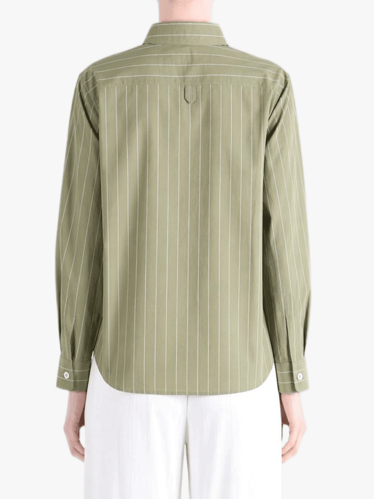 Green shirts worn by a person, showing the shirts's fit