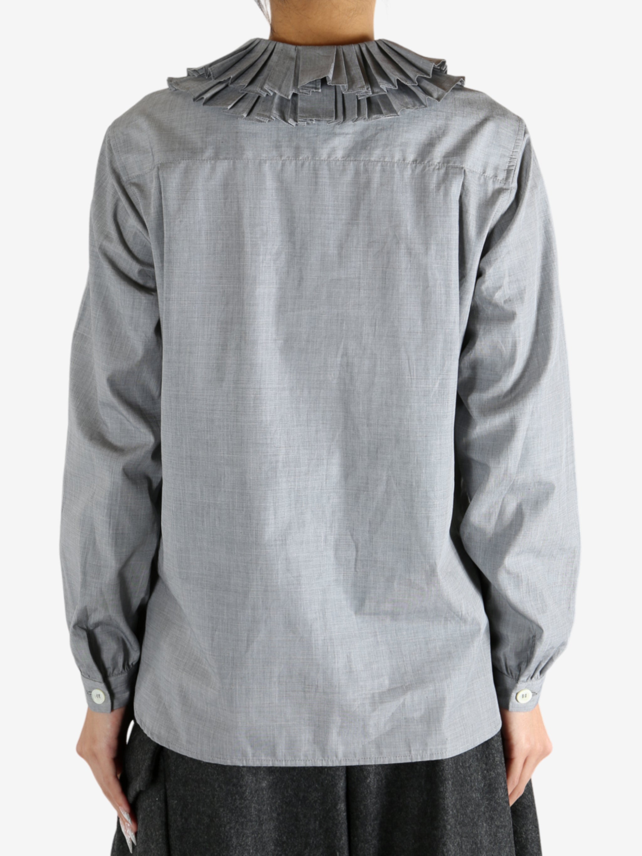 grey shirts worn by a person, showing the shirts fit