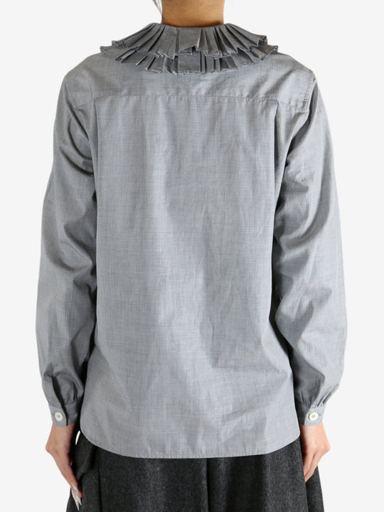 grey shirts worn by a person, showing the shirts fit
