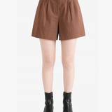 Brown shorts worn by a person, showing the shorts fit