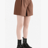 Brown shorts worn by a person, side view