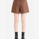 Brown shorts worn by a person, back view