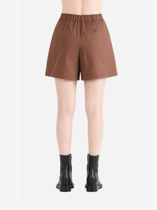 Brown shorts worn by a person, back view
