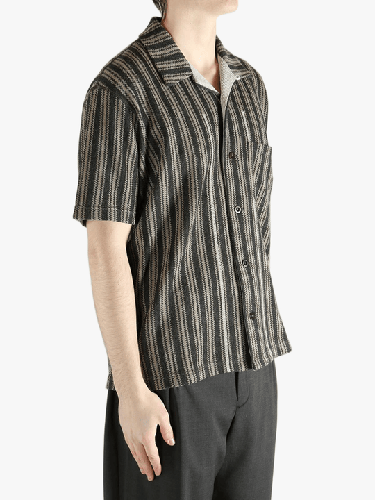 Grey shirt worn by a person, showing the shirt's fit