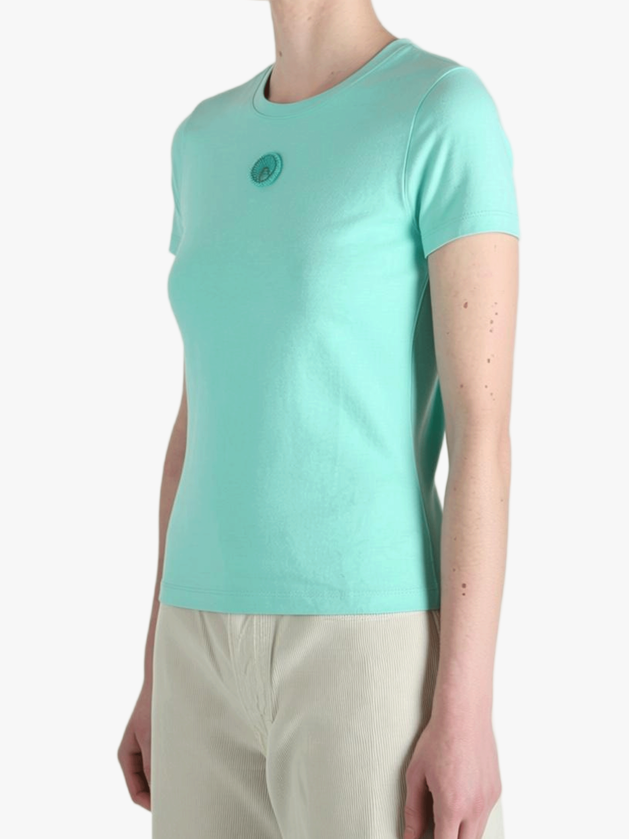 Green t-shirt worn by a person, side view