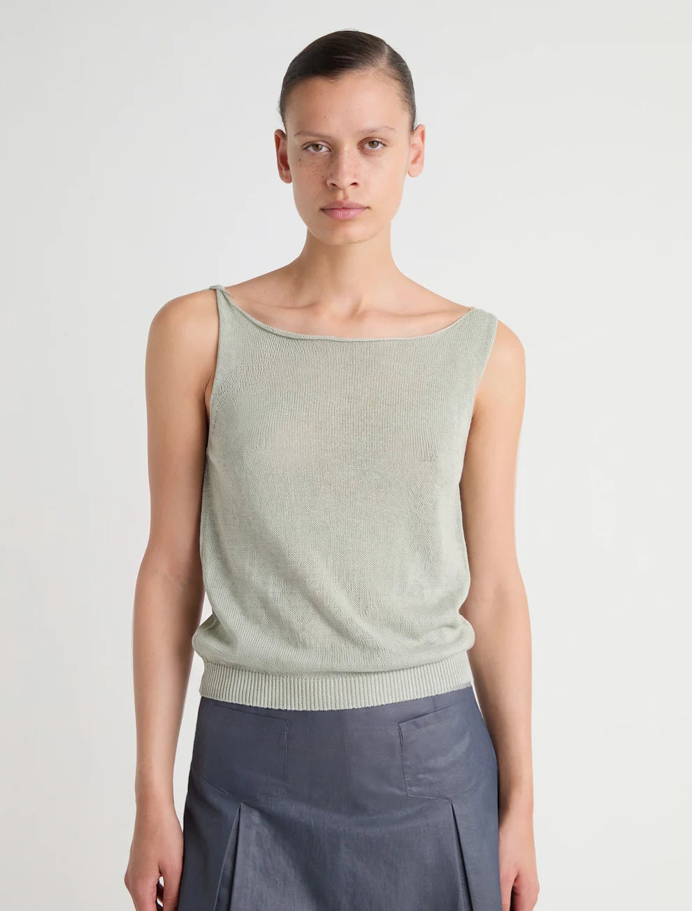 Green top worn by a person, showing the top's fit