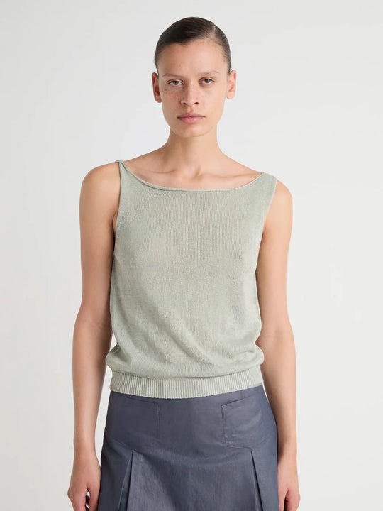 Green top worn by a person, showing the top's fit