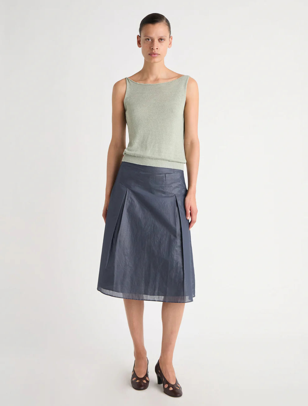Green top worn by a person, showing the top's fit