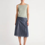 Green top worn by a person, showing the top's fit