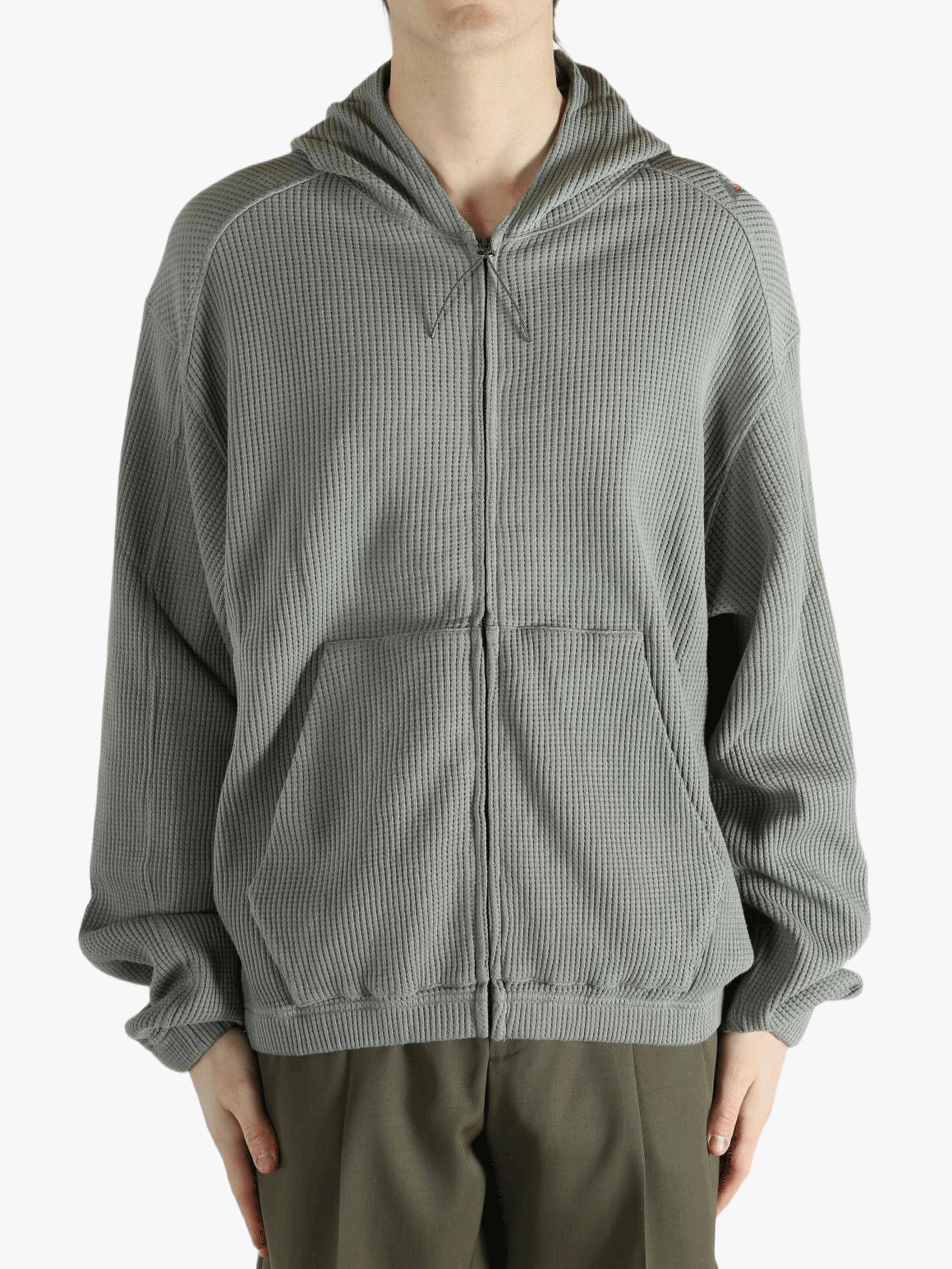 Grey hoodie worn by a person, showing the hoodie's fit