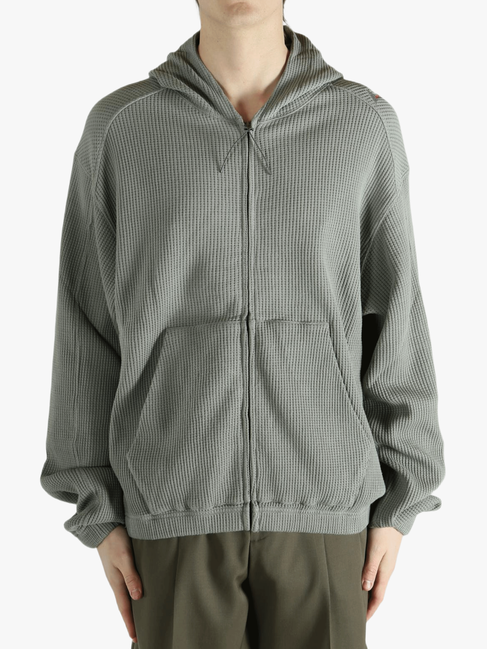 Grey hoodie worn by a person, showing the hoodie's fit