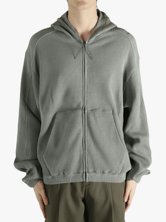 Grey hoodie worn by a person, showing the hoodie's fit
