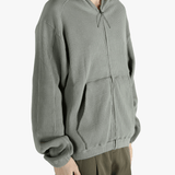 Grey hoodie worn by a person, showing the hoodie's fit