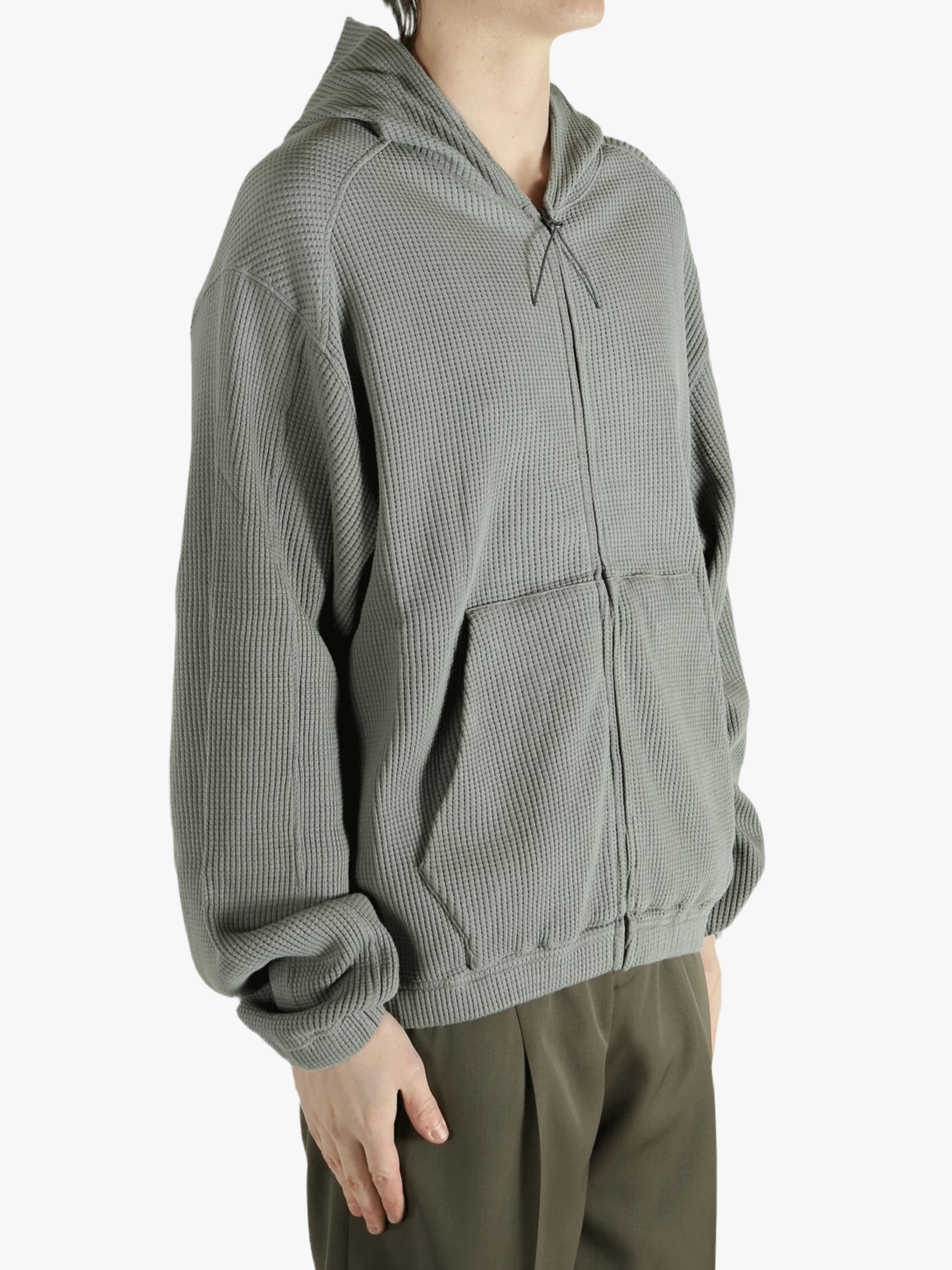 Grey hoodie worn by a person, showing the hoodie's fit