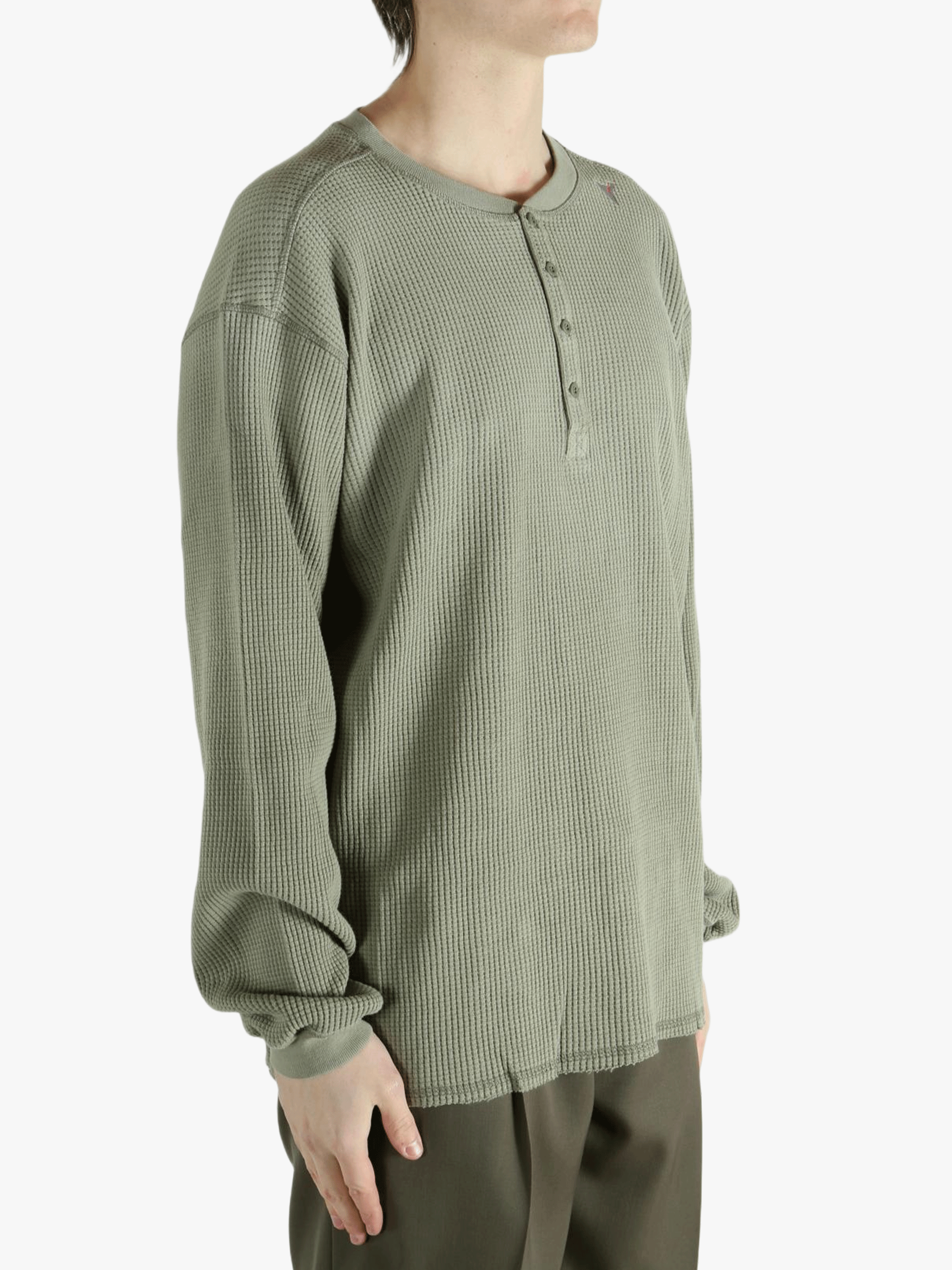 Grey t-shirt worn by a person, showing the shirt's fit