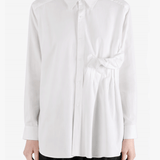 White shirt worn by a person, showing the shirt fit