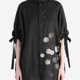 Black shirt worn by a person, showing the shirt fit