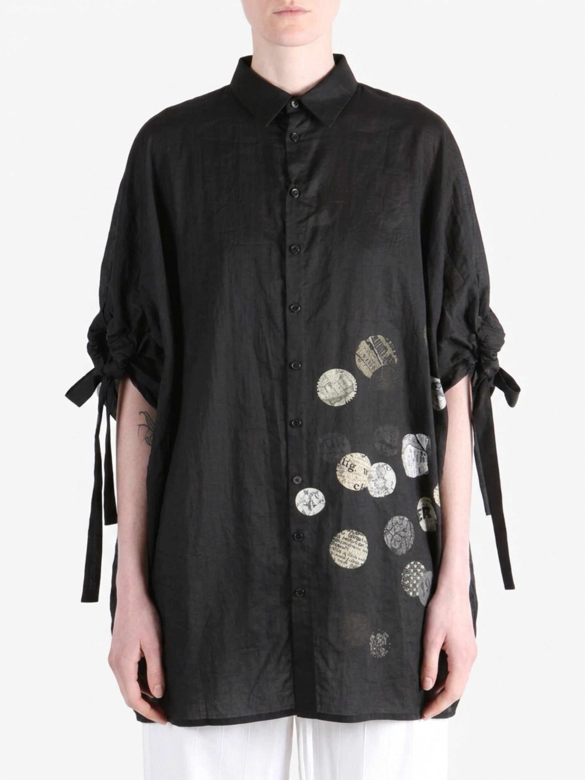 Black shirt worn by a person, showing the shirt fit
