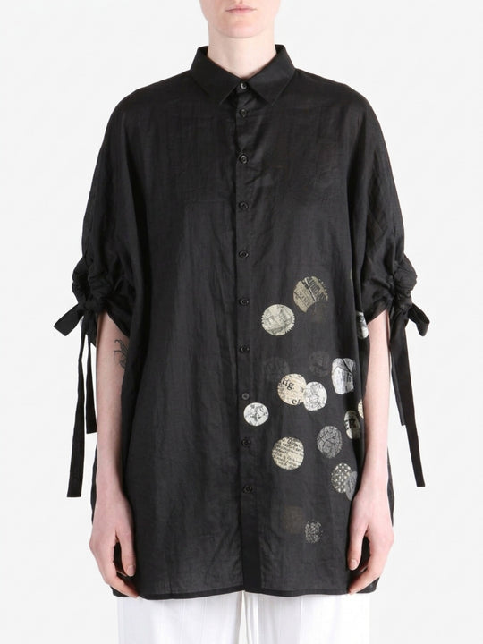 Black shirt worn by a person, showing the shirt fit