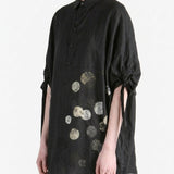 Black shirt worn by a person, side view