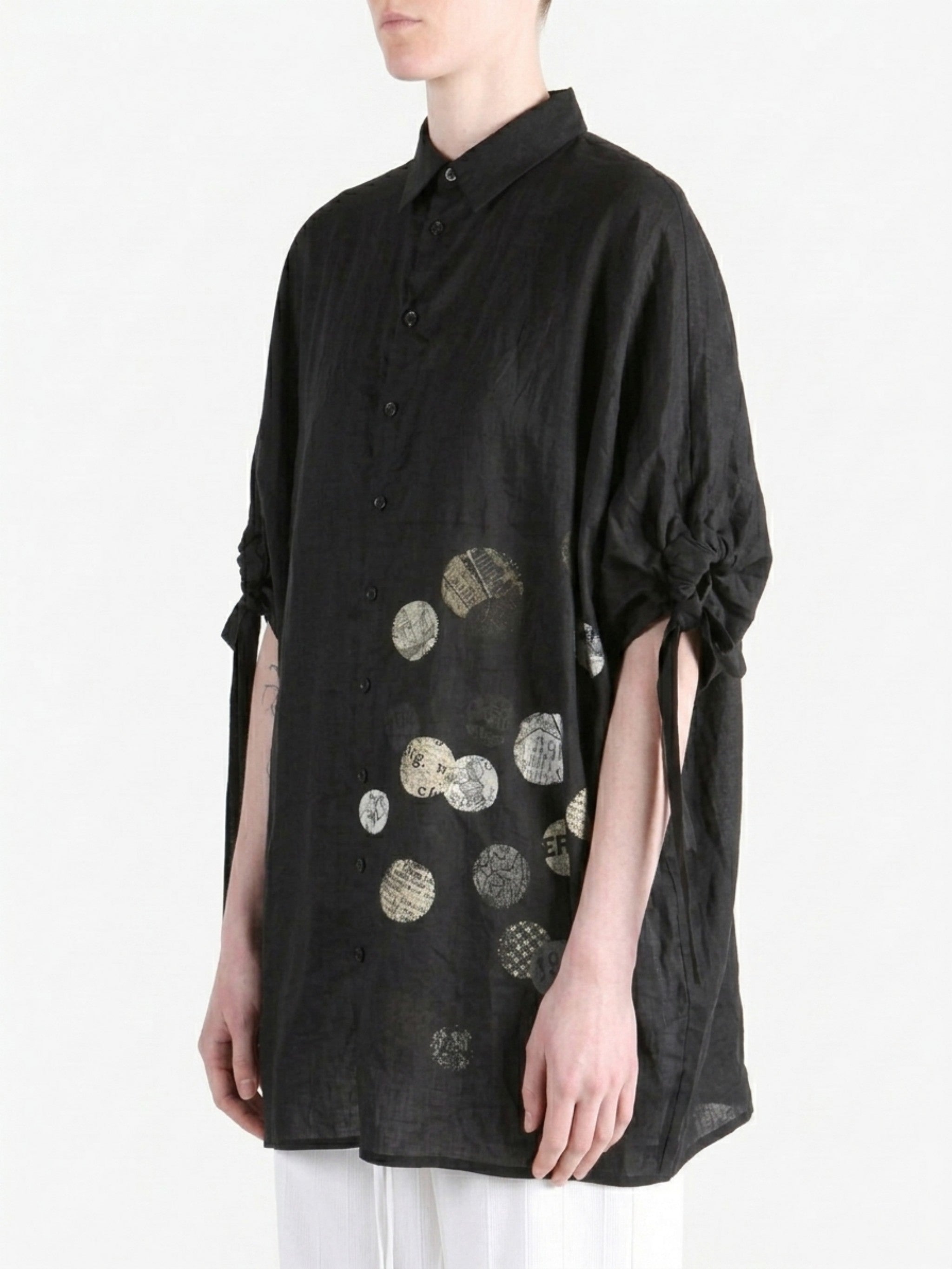 Black shirt worn by a person, side view