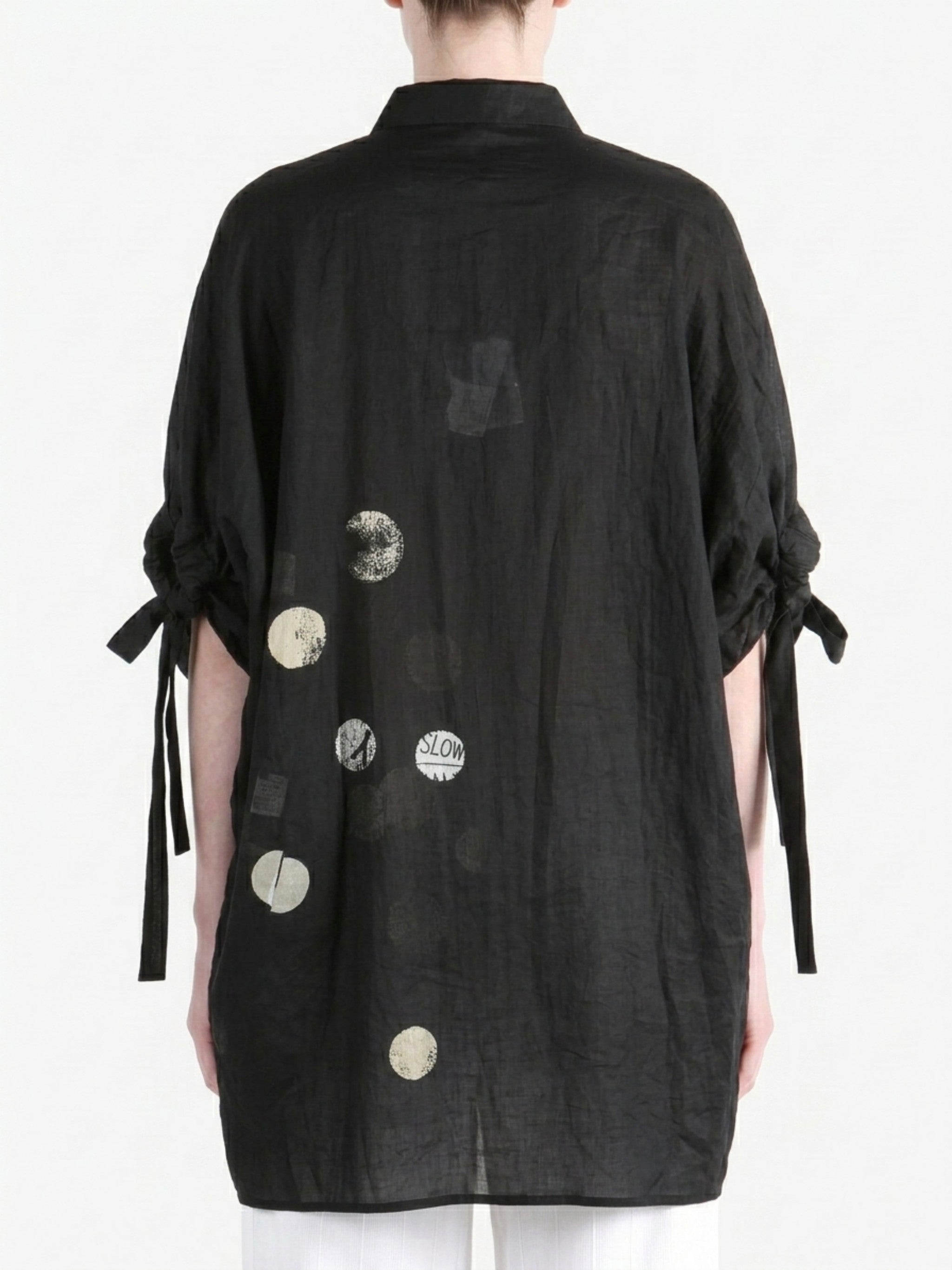 Black shirt worn by a person, back view
