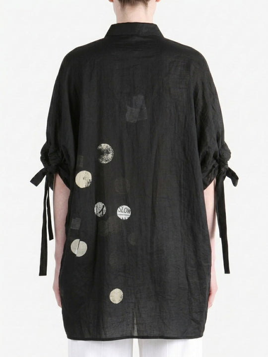 Black shirt worn by a person, back view