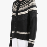 Black knitwear worn by a person, showing the knitwear fit