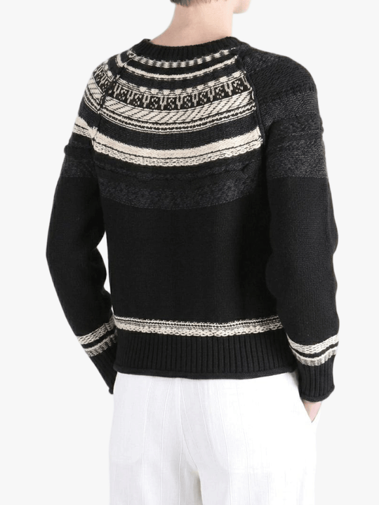 Black knitwear worn by a person, showing the knitwear fit