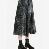 Green pants worn by a person, side view