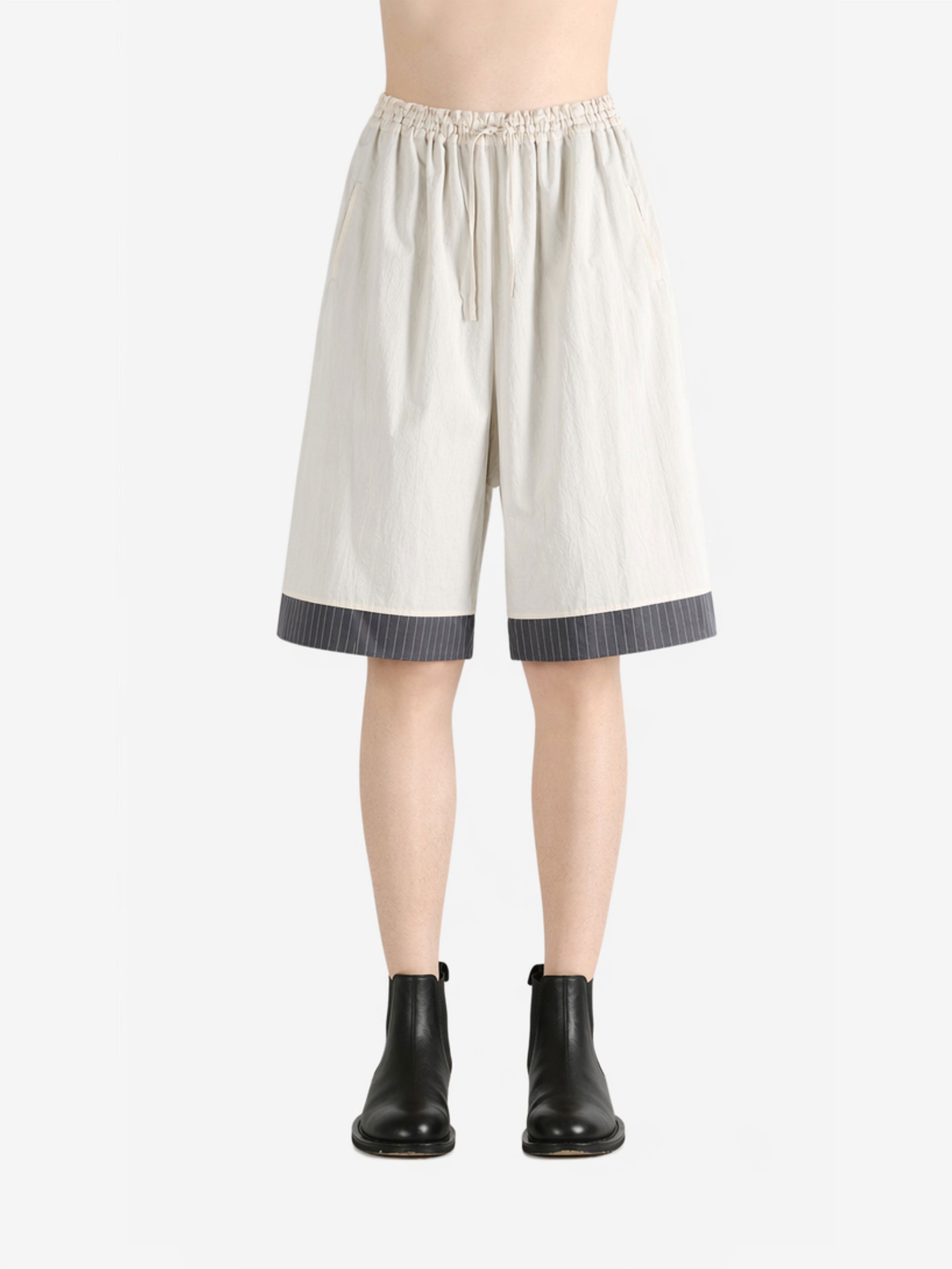 White pants worn by a person, showing the pants fit