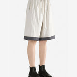 White pants worn by a person, side view