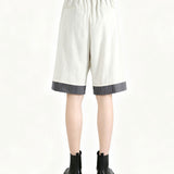 White pants worn by a person, back view