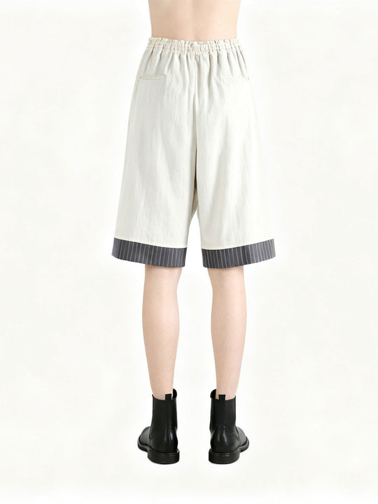 White pants worn by a person, back view