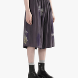 Purple shorts worn by a person, side view