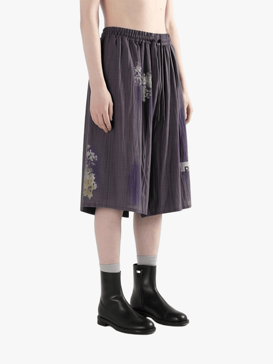 Purple shorts worn by a person, side view