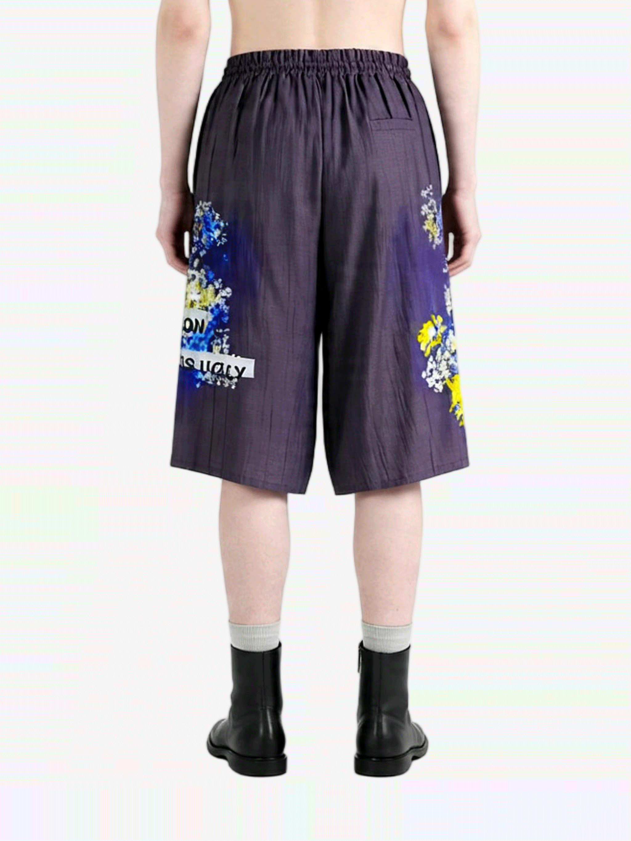 Purple shorts worn by a person, back view