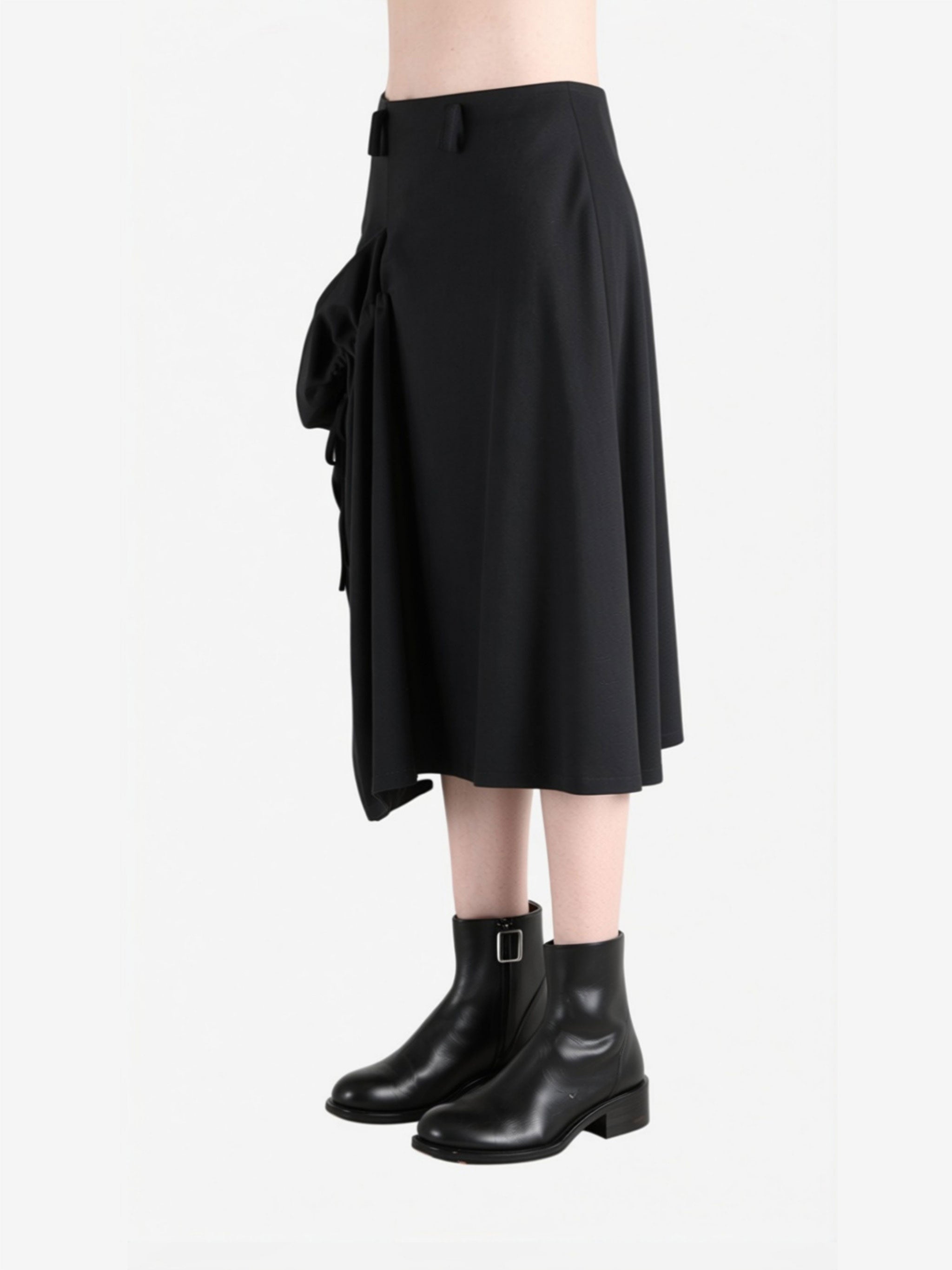Black skirt worn by a person, side view
